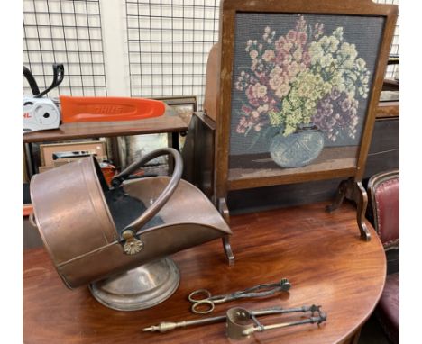 A copper coal scuttle together with fire irons and a woolwork fire screen