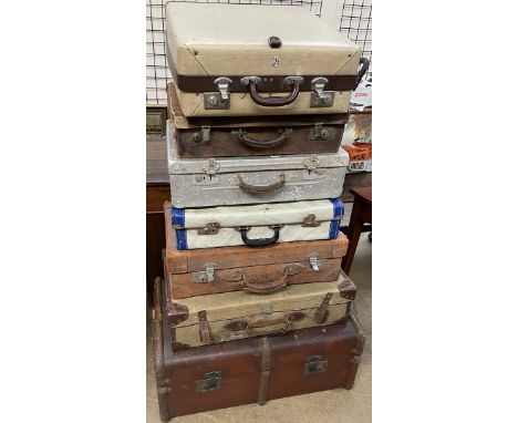 A Rev Robe suitcase together with a collection of suitcases and a trunk