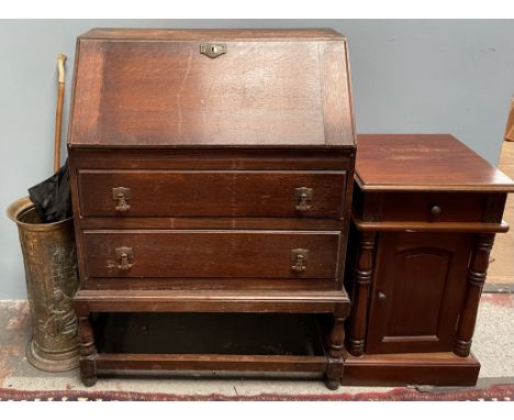 A 20th century oak bureau together with a brass umbrella stand, parasol, walking stick and bedside cabinet