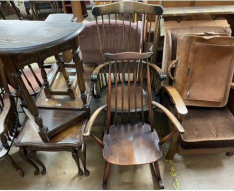 An Ercol stick back elbow rocking chair together with another elbow rocking chair, an upholstered chair, nest of tables, drop