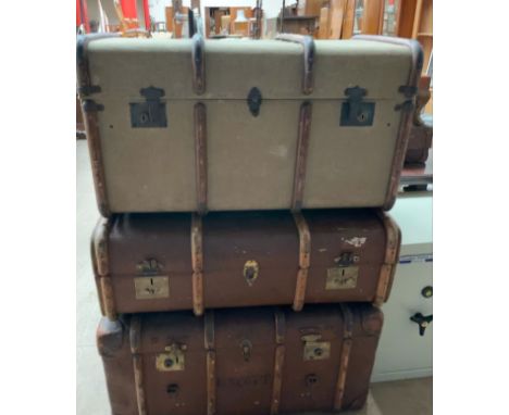 An Atlas three ply banded trunk, together with two other trunks
