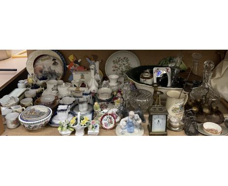 A brass carriage clock together with brass candlesticks, glass decanters, wash basin, crested wares, assorted plates, floral 