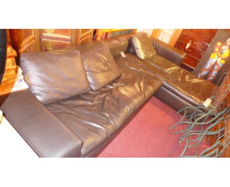 A contemporary Habitat corner sofa upholstered in dark brown leather 