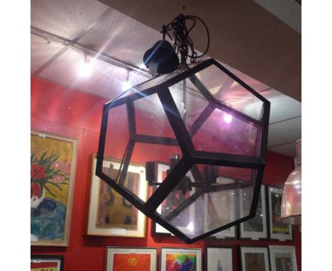 A contemporary many sided hanging light with glazed panels within a black metal frame 