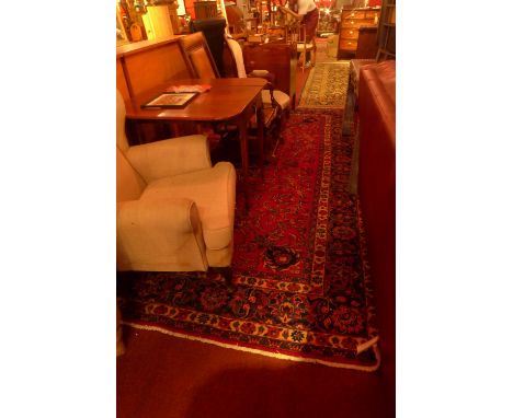 A fine North East Persian Meshad carpet 340cm x 250cm central double pendent medallion with repeating spandrels on a pomegran