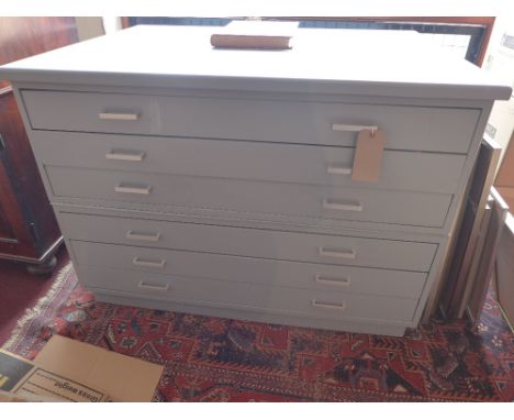 A plan chest of six long drawers painted a light grey/blue colour 
