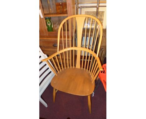 An Ercol beech hoop back Windsor armchair, with an elm seat, the supports joined by H stretcher 