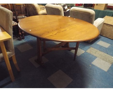 An Ercol Drop Leaf Oval Top Dining Table, 142cm Long When Extended 