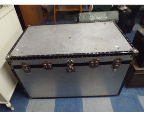 A Large Travelling Trunk Containing Woollen Rug 