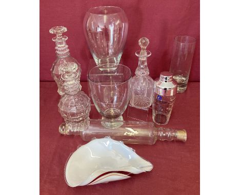 A collection of vintage and modern glassware.  To include decanters, a rolling pin and a cocktail shaker. 