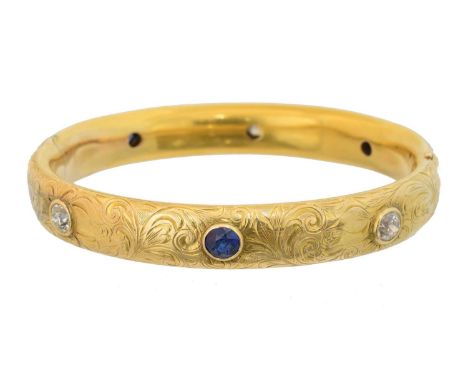 A sapphire and diamond hinged bangle, A sapphire and diamond hinged bangle, the floral engraved bangle set throughout with ci