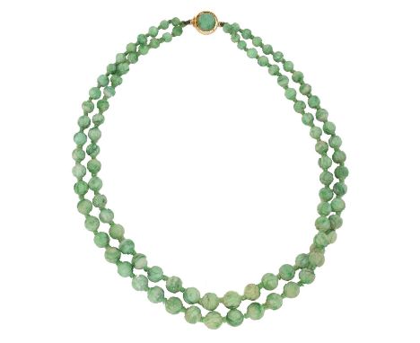 A jade necklace, A jade necklace, the double strand of graduated and carved jade beads, terminating with a jade push piece cl