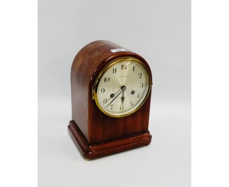 Mahogany cased mantle clock, the arched top over a silvered dial with Arabic numerals inscribed "Henderson's", on four brass 