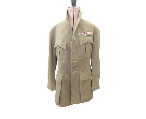 Two post World War I officers tunics, one tunic dated 1924 with medal ribbon for military cross,&nbsp;two green linen shirts 