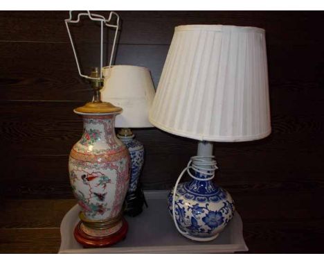THREE ASIAN CERAMIC LAMPS
all in the form of vases, two with carved wood stands, largest 56cm high
Note: Fair condition