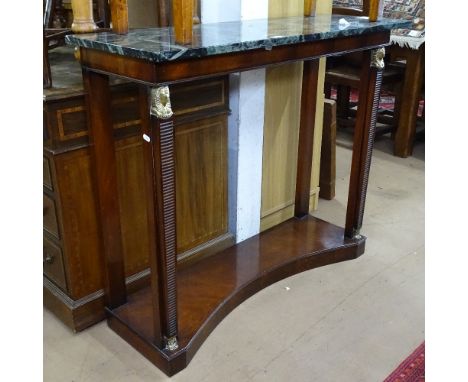 A Regency style Egyptian Revival console table, with a marble top, on reeded tapered legs and figural ormolu mounts, W106cm, 