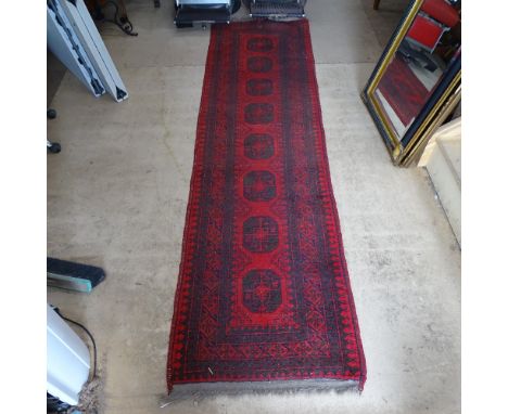 A red ground Turkemon runner, 290cm x 80cm 
