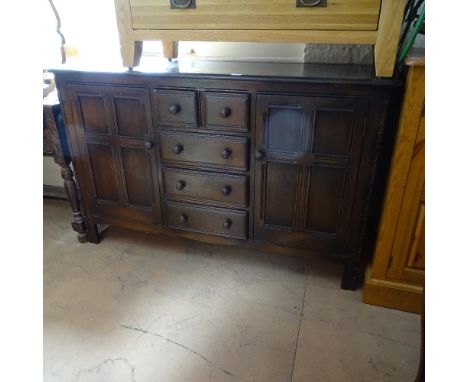 An Ercol dark elm fitted dresser base, W147cm, D50cm, H90cm 