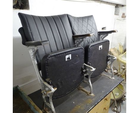 A pair of Vintage cinema seats, mounted on board base, L105cm 