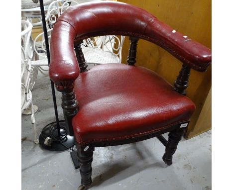 A Victorian upholstered bow-arm desk chair, on ring turned legs 