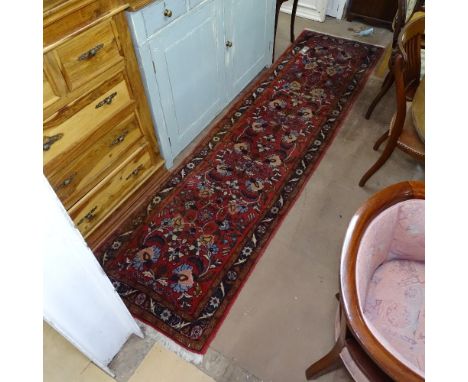 A red ground Persian design runner, 296cm x 75cm 