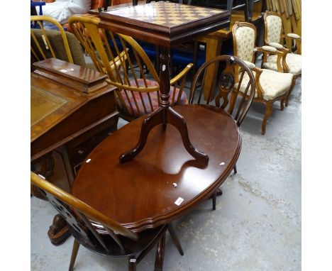 A pair of Ercol stick-back chairs, a mahogany oval coffee table, and a reproduction mahogany games-top occasional table 