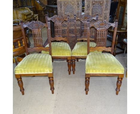 A set of 4 Edwardian carved mahogany dining chairs, with upholstered seats and ring turned legs 