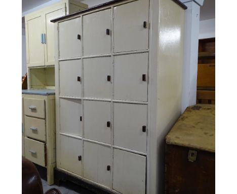 A Vintage painted school locker, with 12 cupboards doors, on bracket feet, W108cm, H150cm, D41cm 