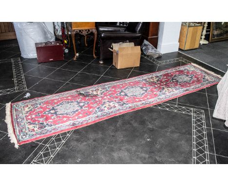 A Woollen Hall Runner, predominately reds, with geometric design.  32" wide x approx. 120" long.