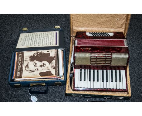 An Antique Piano Accordion with red marbelled body, marked Aloha, together with a teach yourself accordion book and a quantit