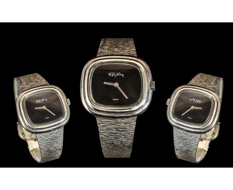 A Roy King Silver Wrist Watch, rectangular shaped case with black dial, textured silver bracelet with buckle fastener.  Fully