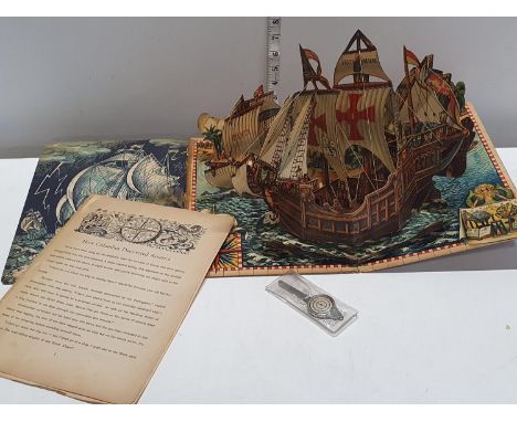 A Christopher Columbus vintage pop up book and a map measuring tool 