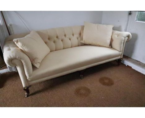 A 19th century three seat settee, button upholstered in a cream linen, on cabriole castored supports, 84" wide x 33" deep, 29