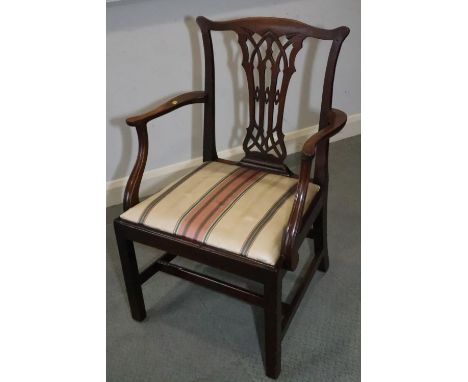 A mahogany carver chair of Chippendale design with Gothic pierced splat and drop-in seat, on chamfered supports