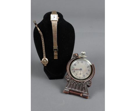 A ladies 9ct gold cased wristwatch and bracelet, a ladies Rotary wristwatch and pocket watch in carved wood standInfo:9ct gol