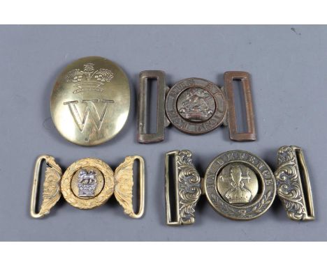 Two British army officer's brass belt buckles, an In Defence brass belt buckle, and a Worldwide Highland Brigade and Scottish
