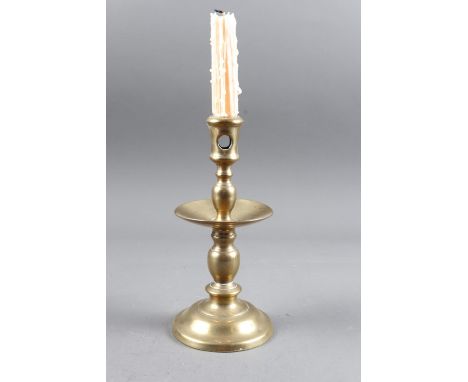 A 17th century brass candlestick with broad drip pan, 8 1/4" high (ex George Shand)