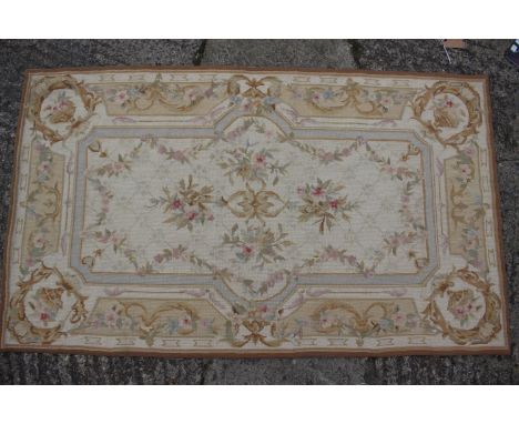 An Aubusson type tapestry rug of traditional design with floral sprays on a cream ground, 34" x 58" approx