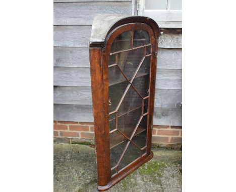An early 18th century walnut archtop corner cabinet enclosed lattice glazed door, 27" wide x 15" deep x 50 1/2" highCondition