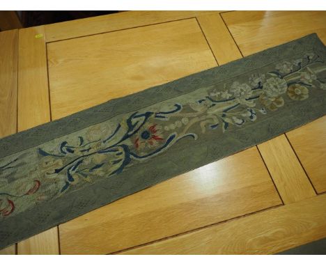 A runner made of a fragment of 18th century Beauvais tapestry with later metal thread edging, 11" x 49" (ex Joanna Booth)