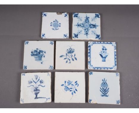 An early 18th century Liverpool delft blue and white floral decorated tile, five similar tiles with flowers and two decorativ