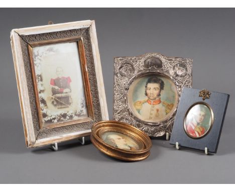 An embossed silver photo frame with watercolour of a French military officer, a photograph of a military officer and two port