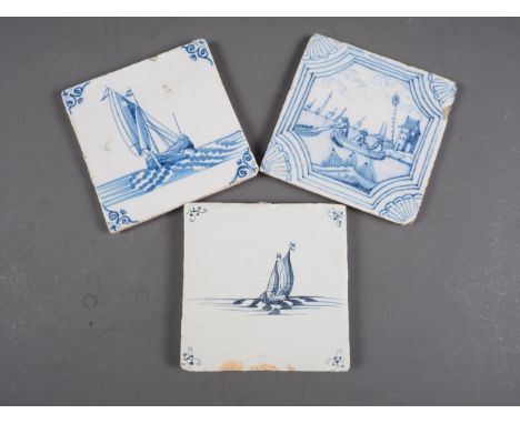 An early 18th century London delft blue and white tile with fishing boat and two 18th century delft tiles with barges 