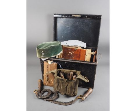 A Commando chain saw, a quantity of canvas bags, pouches, hats and other items, contained in a tin trunk