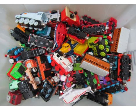 A box of train toys including Thomas the Tank Engine 