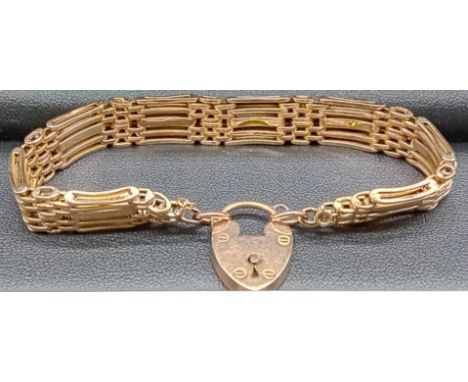 9ct yellow gold gate bracelet with a heart lock fitted. [16.02grams] 