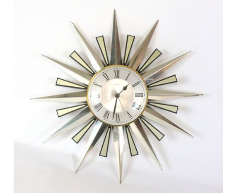 A Metamec Quartz wall clock with a metallic sunburst frame, d. 60 cm   CONDITION REPORT:  D. (all) 60cmD. (face) 21cmUnsure o