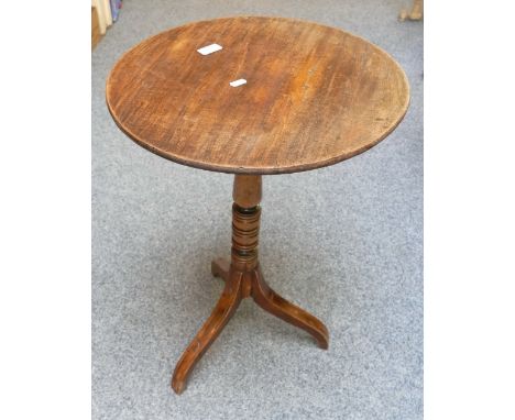 A tripod tilt-topped table