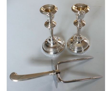 A pair of silver candlesticks, together with a silver handled fork (3)