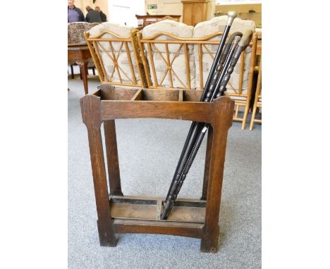 An oak stick stand with drip-trays and 2 horn handled sticks and 2 ebonised canes